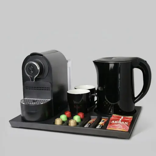 Set Kettle 1.2l & Melamine Tray — CTS-1034 — A welcome-tray set combining a melamine tray with a 1.2L stainless steel kettle and a capsule coffee machine. The double-body kettle wraps food-grade 304 steel in a cool-touch PP shell with automatic shut-off. The 41.9x31.4cm tray holds cups, sachets, a spoon and six espresso capsules for complete in-room beverage service.