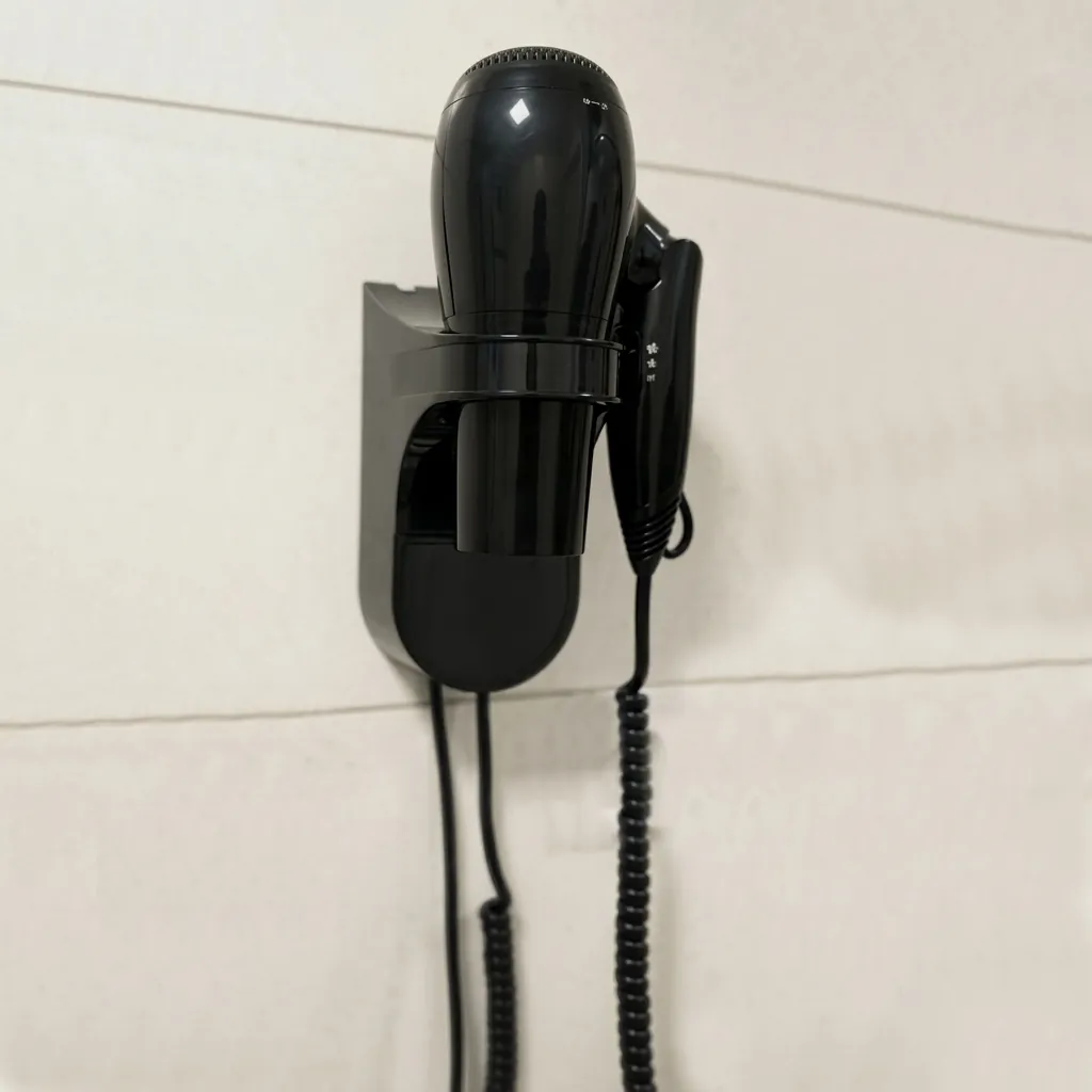 Wall Mounted Foldable Hair Dryer 1800 2100W — HDR-1025 — A wall-mounted foldable hair dryer rated 1800 to 2100W with three heat and two speed settings plus an ionic function for softer hair. A branded motor keeps it quiet and stable, with overheat protection and automatic shut-off for safety. The retractable 1.8m cord, foldable handle and removable filter make it tidy and easy to clean. CE, CB, GCC and RoHS approved. (image 3)