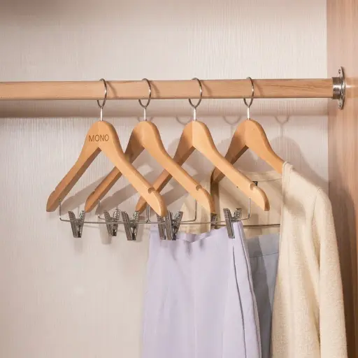 Maple Wood Anti-Theft Clothes Hanger with Clips — HNG-1028 — An anti-theft maple wood hanger with a fixed chrome hook and integrated clips for trousers and skirts. Sturdy and smooth, it keeps garments crease-free while staying secured to the wardrobe rail. Supplied 100 pieces per carton, measuring 44.5cm wide.