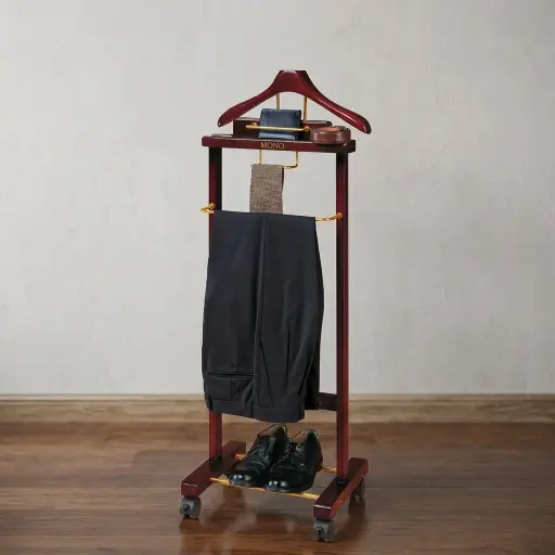 Floor Standing Wooden Clothes Rack — HNG-1030 — A rubber wood valet stand with gold-tone hardware that organises a suit, tie, trousers and small accessories in one elegant piece. A coat hanger, tray platform, tie holder and trouser rod keep the morning routine tidy beside the bed. A classic 460x350x1150mm stand for refined guest rooms.