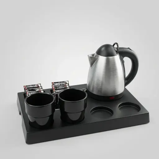 ABS Tray Set with Strix Stainless Steel 0.8L Kettle — KTS-1087 — A three-in-one matt ABS welcome tray with a fixed kettle base, three sachet-and-spoon compartments and space for four cups. Rounded corners keep it easy to clean, paired with a 0.8L Strix-controlled stainless steel kettle. A 40.5x26.8cm tray, in stainless steel or black.