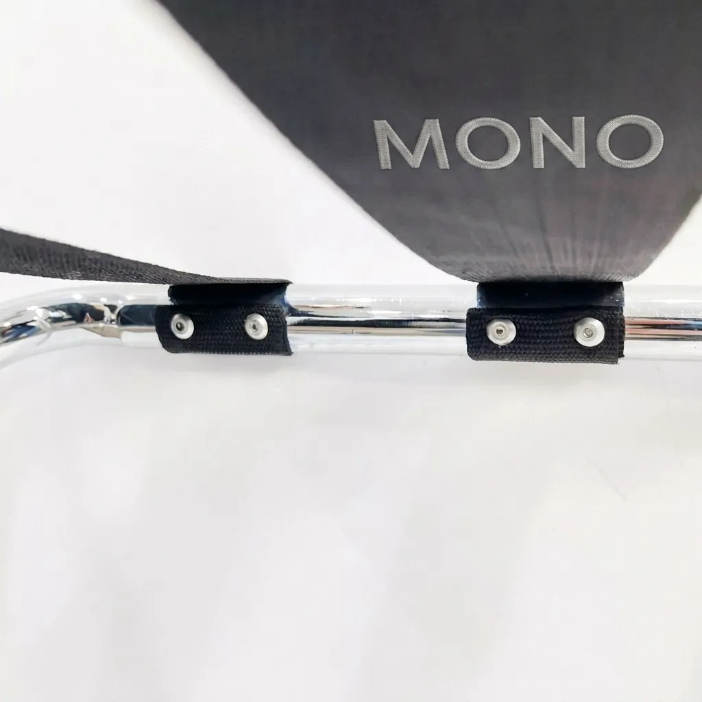 Folding Luggage Rack Backless Stainless Steel — LGR-1024 — A folding backless luggage rack with a sturdy 1-inch stainless steel round-tube frame and four wide 5cm nylon straps to hold heavy bags securely. The flat-and-round tube design looks modern, while plastic foot caps keep it stable and non-slip. Folds flat for storage, measuring 600x425x500mm, in polished steel, brushed steel, titanium gold or black. (image 2)