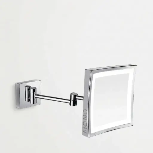Wall-Mounted Magnifying Mirror with LED Light [1050] — MGM-1050 — A wall-mounted single-sided 3x magnifying mirror with a built-in LED light on an extending arm for flexible positioning. The 20cm square copper-framed mirror uses a long-life 60,000-hour LED. Dual-voltage 110/220V.