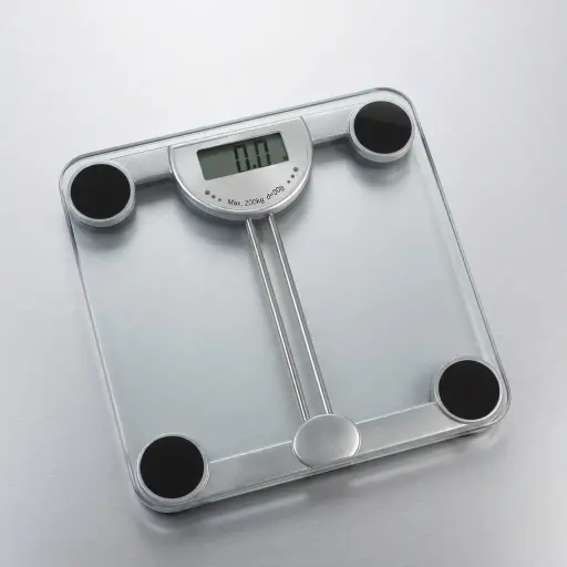 Tempered Glass Digital Bathroom Scale with 50g Division — SCL-1034 — A digital bathroom scale with a tempered glass platform and 4-sensor technology for precise weighing up to 200kg in fine 50g steps. An LCD shows kg, lb or stone, with low-battery and overload indicators. Powered by 2 AAA batteries, measuring 30.2x30.2x3.3cm.